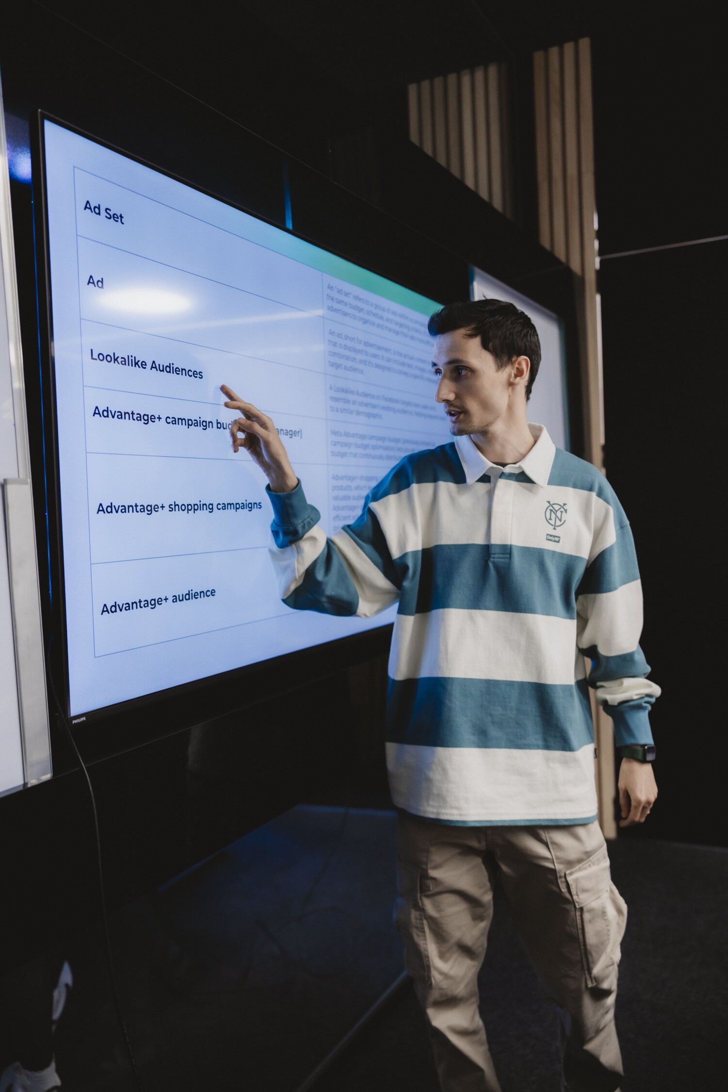 http://Instructor%20at%20Growzillas%20Academy%20pointing%20at%20a%20large%20screen%20displaying%20Facebook%20Ads%20campaign%20structure%20during%20a%20digital%20marketing%20class